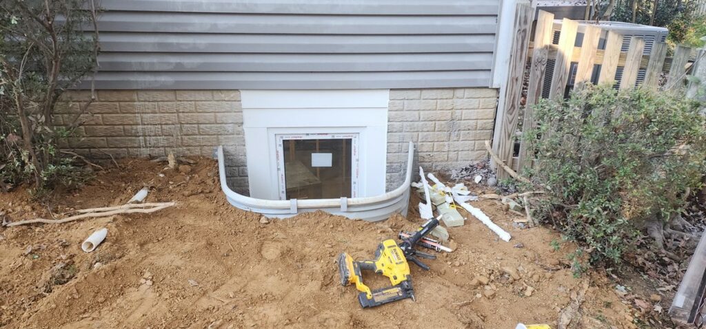 Excavation and drainage work for egress window installation in Burke VA