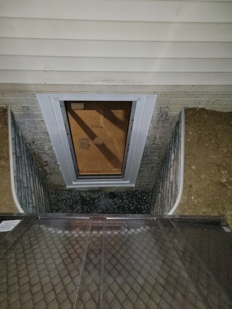 Newly installed 30x60 egress window with window well in Vienna VA basement