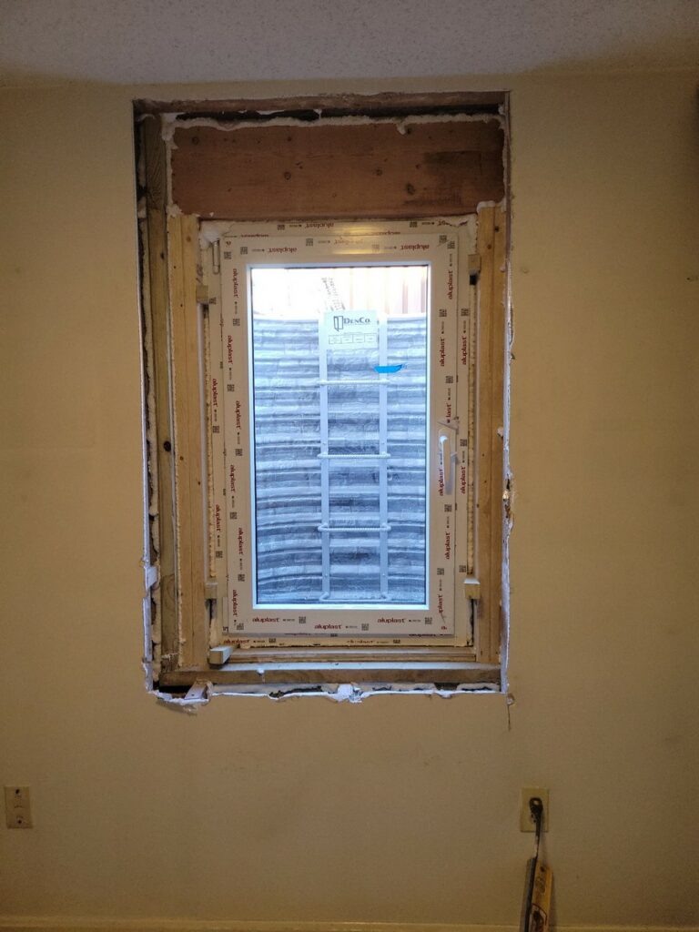 Newly installed 30x60 egress window with window well in Vienna VA basement